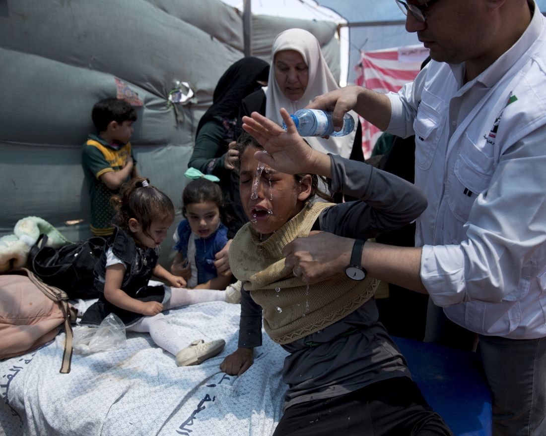 Medics treat Palestinian children suffering from teargas inhalation during a protest near Beit Lahiya, Gaza Strip, Monday, May 14, 2018. Israeli soldiers shot and killed dozens of Palestinians during mass protests along the Gaza border on Monday. It was the deadliest day there since a devastating 2014 cross-border war and cast a pall over Israel's festive inauguration of the new U.S. Embassy in contested Jerusalem. (AP Photo/Dusan Vranic)