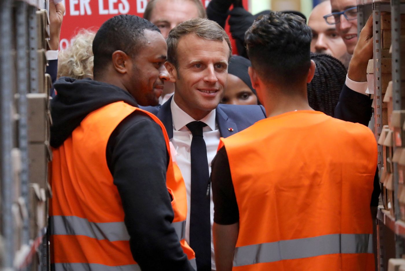 In this photo taken on Tuesday Sept. 10, 2019 French President Emmanuel Macron listens to warehouse workers in Bonneuil-sur-Marne, southwest of Paris. French President Emmanuel Macron was a world away from the glamor of hosting world leaders at a G-7 summit a few weeks earlier. This time, those he was trying to win over weren't President Donald Trump and other heads of states in the luxurious seaside resort of Biarritz, but workers struggling to make ends meet. (Ludovic Marin, Pool via AP)