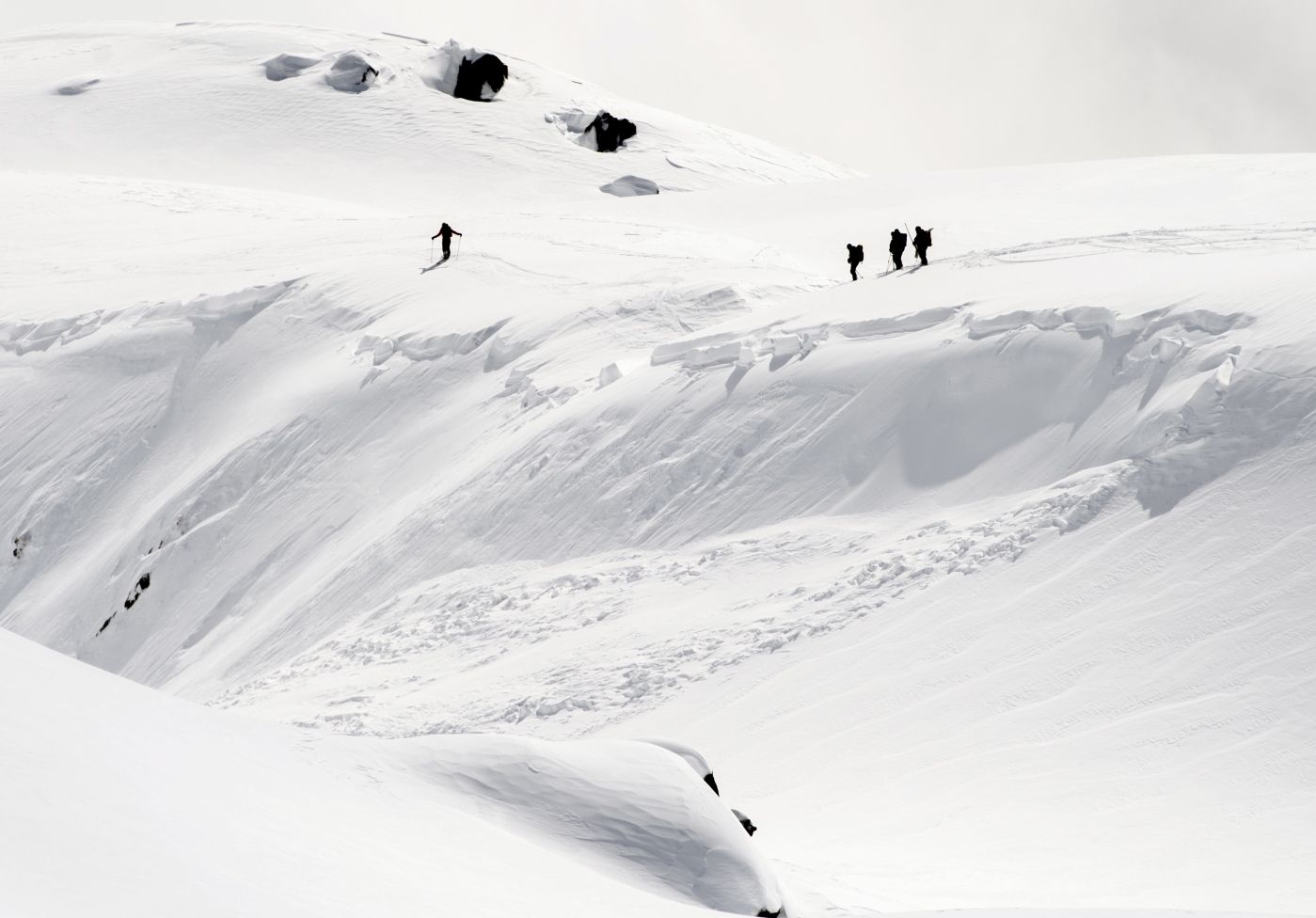 Rescue crews walk at an avalanche site near Fiesch, Switzerland, Sunday, April 1, 2018. Swiss police say three people have been killed in an avalanche in the Alps. Another two were taken to a hospital with light injuries. Police  say the avalanche hit the group of five skiers on Saturday afternoon. The group had set off from an Alpine hut earlier in the day to cross the Aletsch glacier in southern Switzerland. (Jean-Christophe Bott/Keystone via AP)