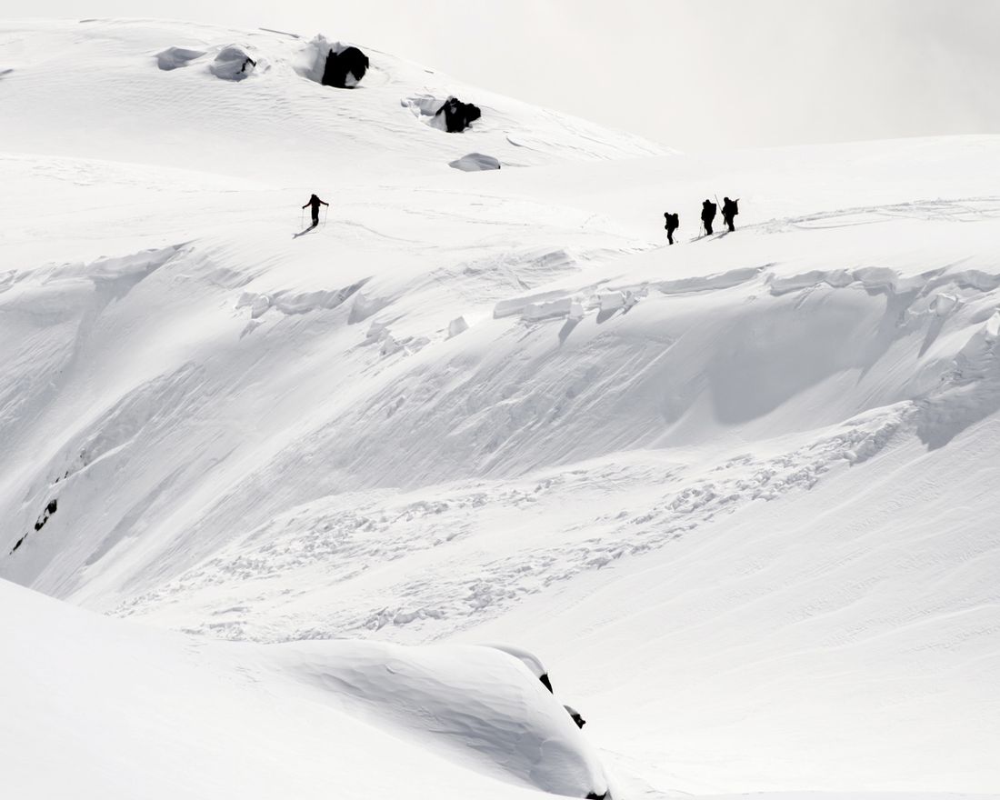 Rescue crews walk at an avalanche site near Fiesch, Switzerland, Sunday, April 1, 2018. Swiss police say three people have been killed in an avalanche in the Alps. Another two were taken to a hospital with light injuries. Police  say the avalanche hit the group of five skiers on Saturday afternoon. The group had set off from an Alpine hut earlier in the day to cross the Aletsch glacier in southern Switzerland. (Jean-Christophe Bott/Keystone via AP)