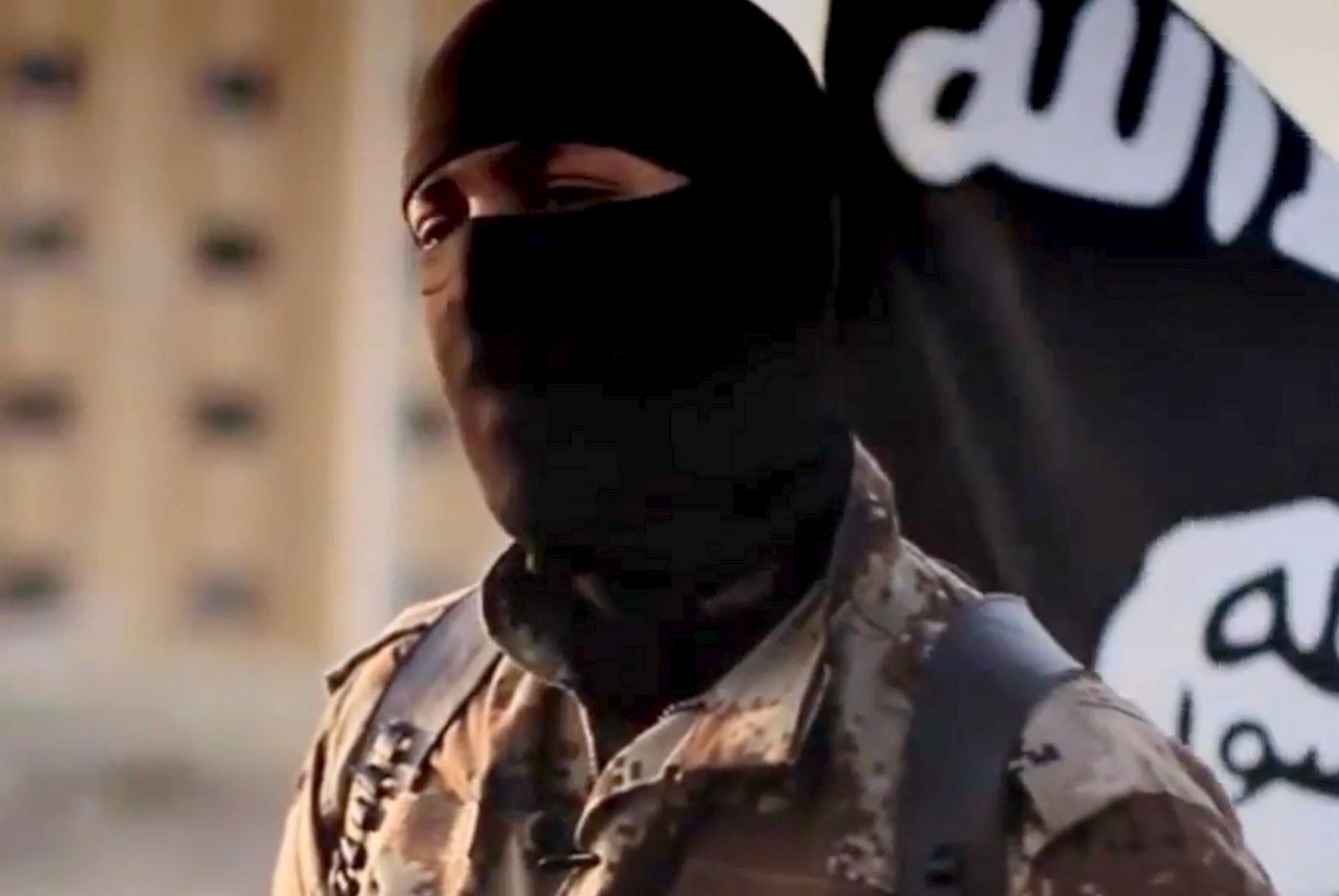 This image taken from video released October 7, 2014 by the Federal Bureau of Investigation(FBI) shows an English-speaking individual, who was seen in a propaganda video released in September of 2014 by the group calling itself the Islamic State of Iraq and the Levant, or ISIL. The FBI is seeking information on the man, whose face is obscured by a mask and alternates seamlessly between English and Arabic in pro-ISIL pronouncements intended to appeal to a Western audience. Dressed in desert camouflage and wearing a shoulder holster, the masked man can be seen standing in front of purported prisoners as they dig their own graves and then later presiding over their executions. The man has what is believed to be a North American accent. AFP PHOTO / HANDOUT  / FEDERAL BUREAU of INVESTIGATION             == RESTRICTED TO EDITORIAL USE / MANDATORY CREDIT: "AFP PHOTO / HANDOUT / FEDERAL BUREAU of INVESTIGATION "/ NO MARKETING / NO ADVERTISING CAMPAIGNS / NO A LA CARTE SALES / DISTRIBUTED AS A SERVICE TO CLIENTS ==
