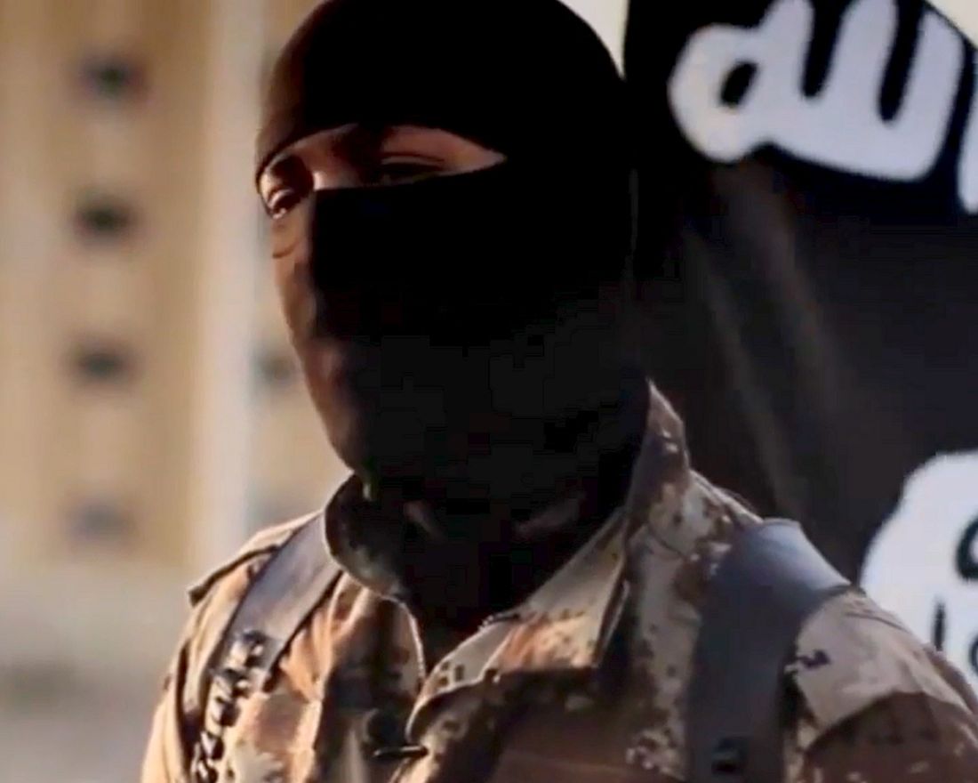 This image taken from video released October 7, 2014 by the Federal Bureau of Investigation(FBI) shows an English-speaking individual, who was seen in a propaganda video released in September of 2014 by the group calling itself the Islamic State of Iraq and the Levant, or ISIL. The FBI is seeking information on the man, whose face is obscured by a mask and alternates seamlessly between English and Arabic in pro-ISIL pronouncements intended to appeal to a Western audience. Dressed in desert camouflage and wearing a shoulder holster, the masked man can be seen standing in front of purported prisoners as they dig their own graves and then later presiding over their executions. The man has what is believed to be a North American accent. AFP PHOTO / HANDOUT  / FEDERAL BUREAU of INVESTIGATION             == RESTRICTED TO EDITORIAL USE / MANDATORY CREDIT: "AFP PHOTO / HANDOUT / FEDERAL BUREAU of INVESTIGATION "/ NO MARKETING / NO ADVERTISING CAMPAIGNS / NO A LA CARTE SALES / DISTRIBUTED AS A SERVICE TO CLIENTS ==