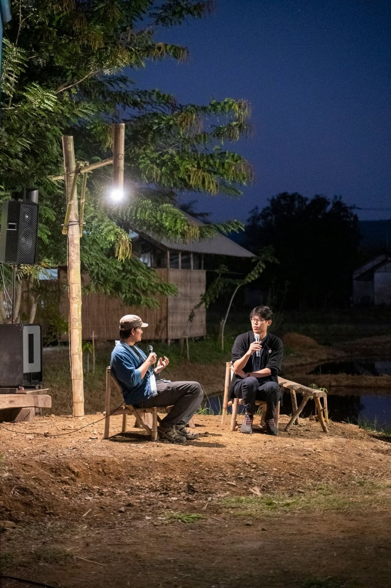 Two speakers in conversation outdoors at Pham