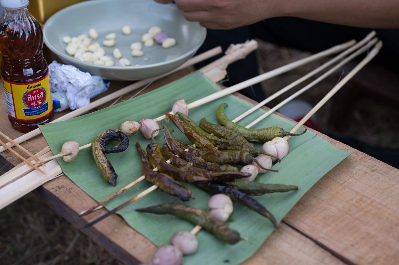 Local peppers and garlic prepared on bamboo skewers