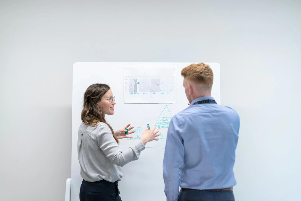 person infront of a board - MLOps Best Practices