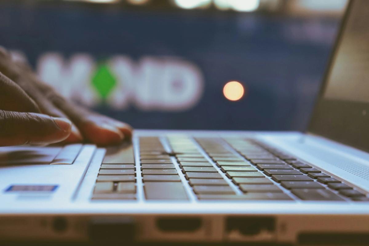 Person Working on Laptop - LLM Performance Metrics