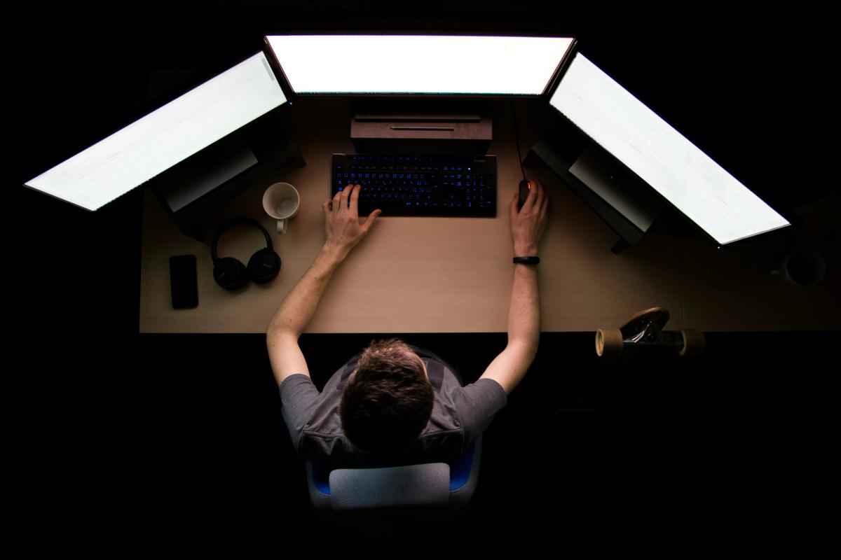 man coding infront of computers - Llama CPP