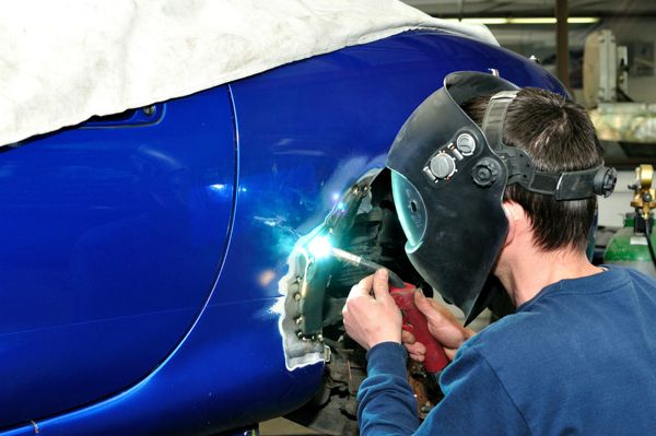 Technician welding a panel