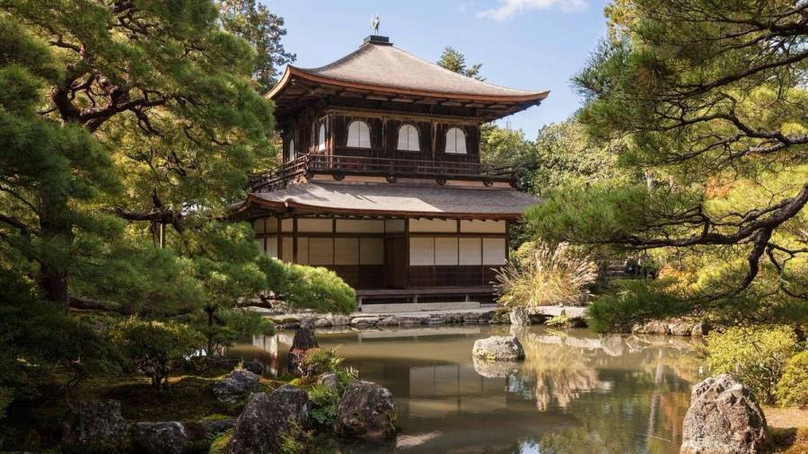 Ginkaku-ji, the Silver Pavilion, viewed across its reflecting pond in eastern Kyoto, framed by carefully pruned pines.