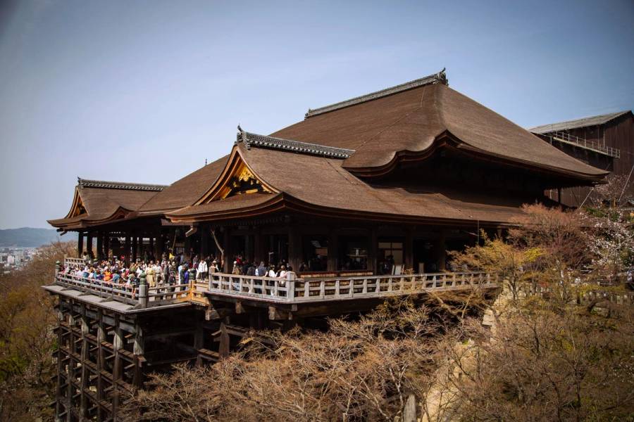 Kiyomizudera Temple famous wooden stage packed with hundreds of tourists in Kyoto showing overtourism problem.