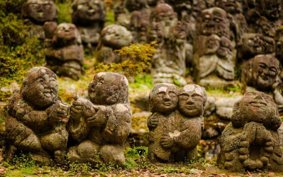 Rakan statues, Buddhist stone statues, surrounded by moss at Otagi-Nenbutsuji Temple, Kyoto, Japan. 