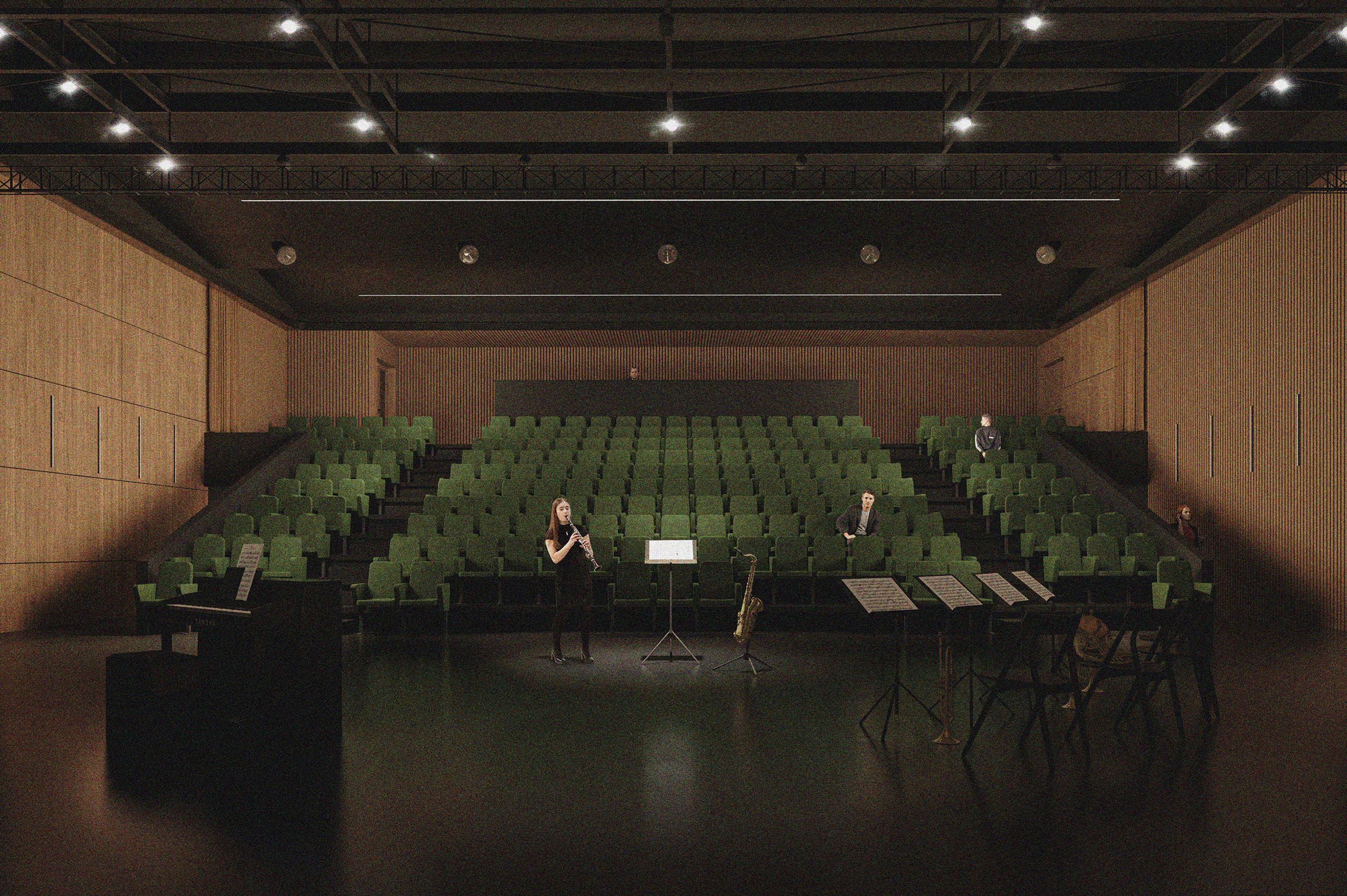 Vue de processus de l’auditorium du conservatoire d’Annemasse : gradins aux sièges verts, parois acoustiques en bois et plafond technique noir.