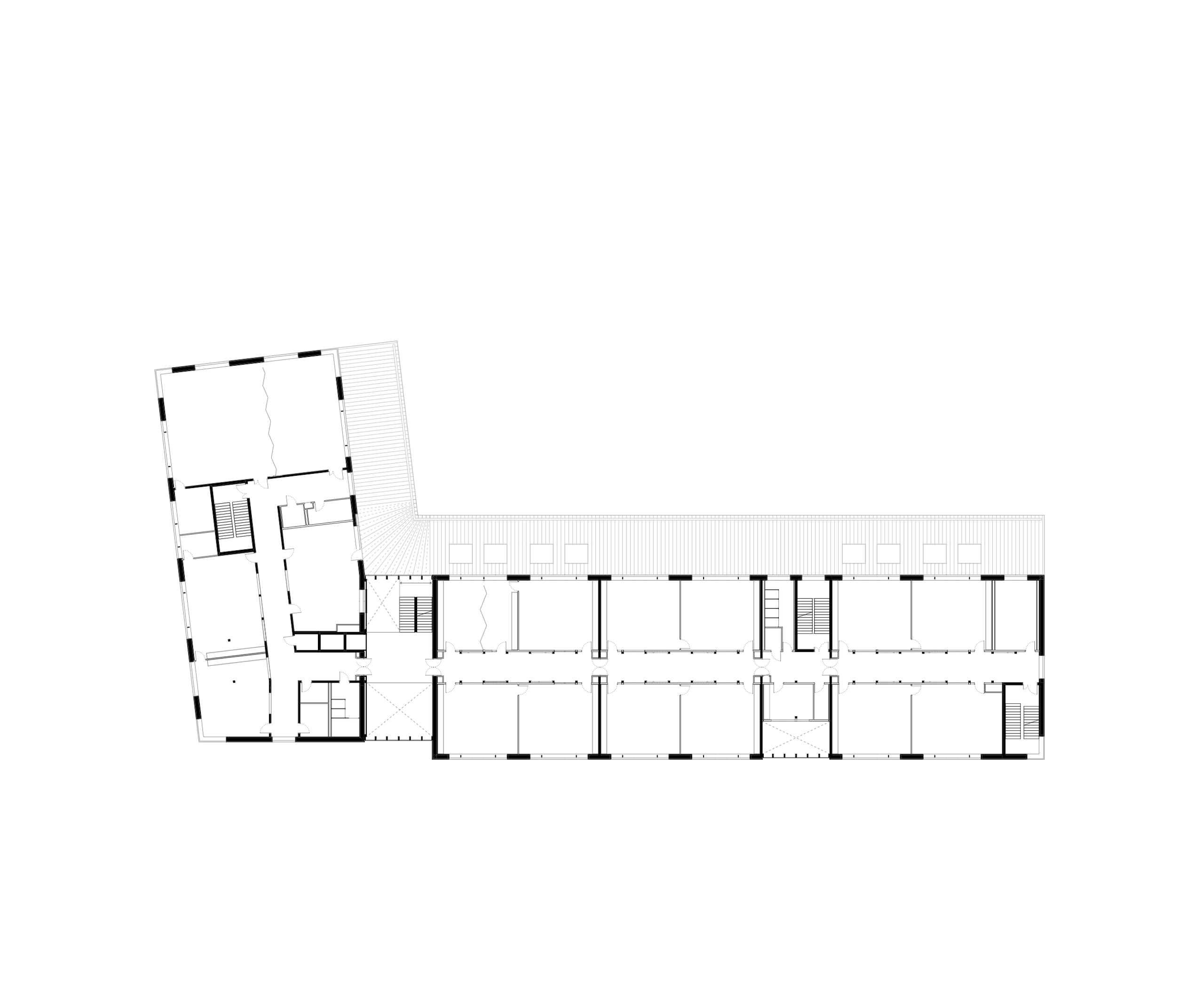 Plan d’étage du groupe scolaire J.F. Kennedy à Lyon, montrant un bâtiment en L, distribution linéaire des salles de classe et circulations longitudinales.