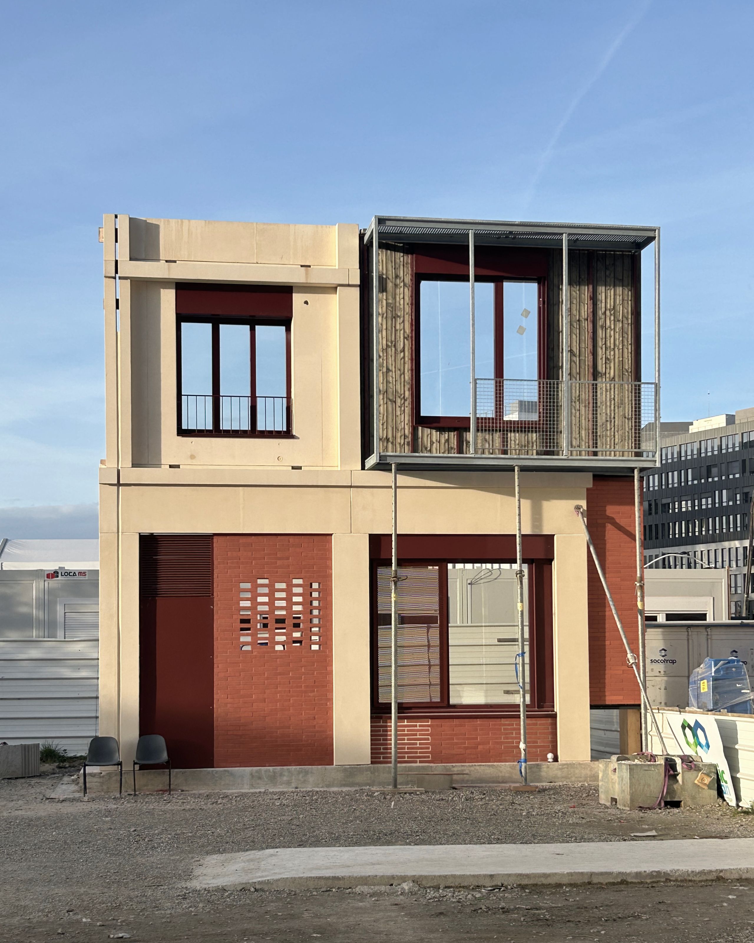 Process mock-up for Mixed-Use Blocks in Bordeaux, showing two-storey facade with prefabricated concrete, red brick, metal frame loggia and large openings.