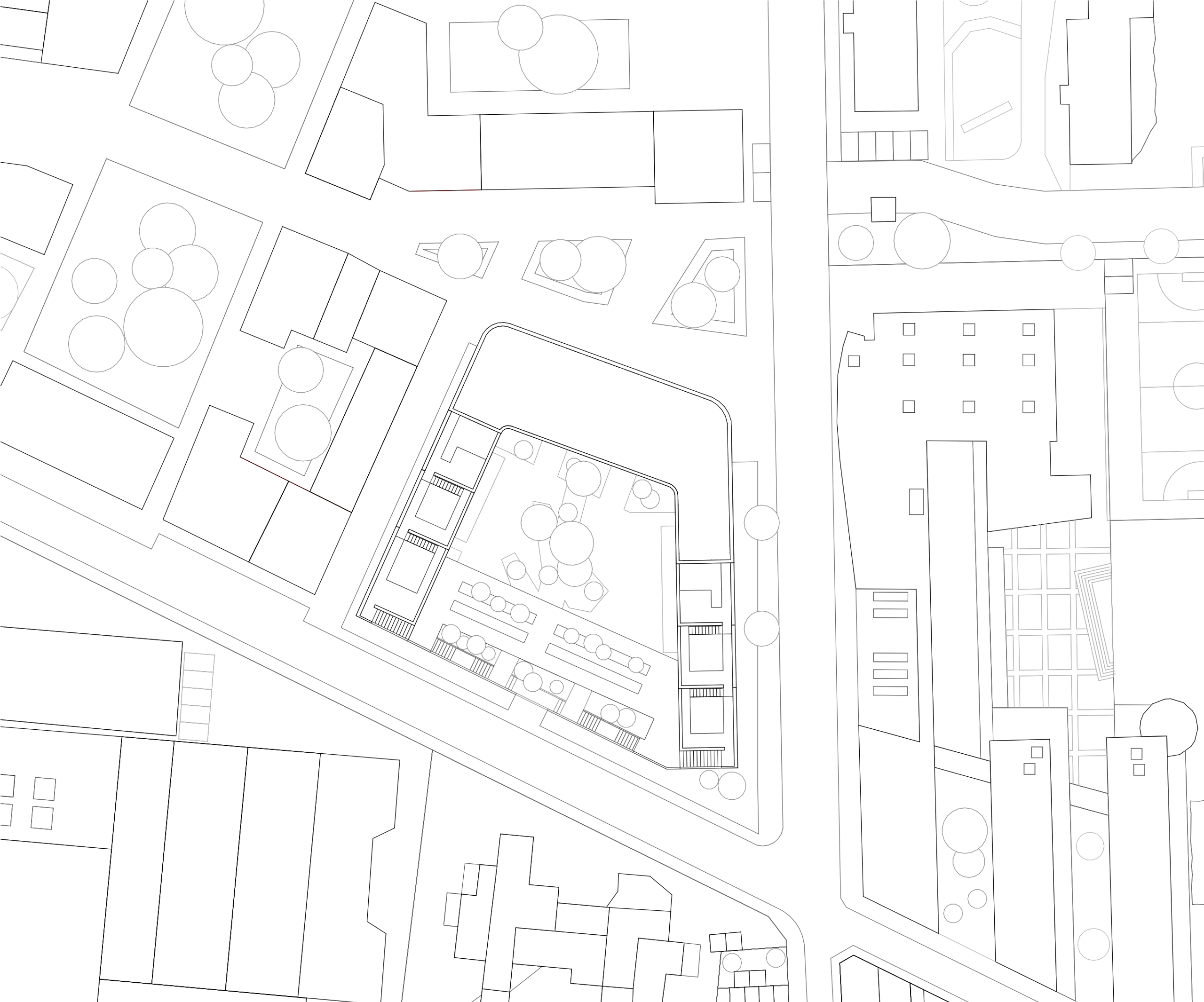 Plan masse du groupe scolaire Dominique Frelaut à Colombes, bâtiment en U enveloppant la cour plantée, inséré dans un tissu urbain dense et hétérogène.