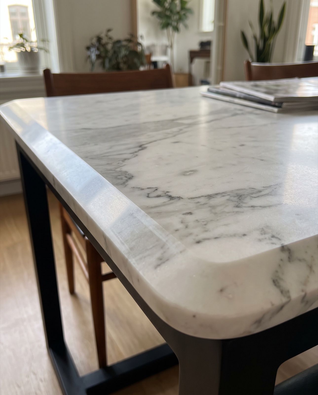 A white marble table top with a wide, shallow slope running around its edge
