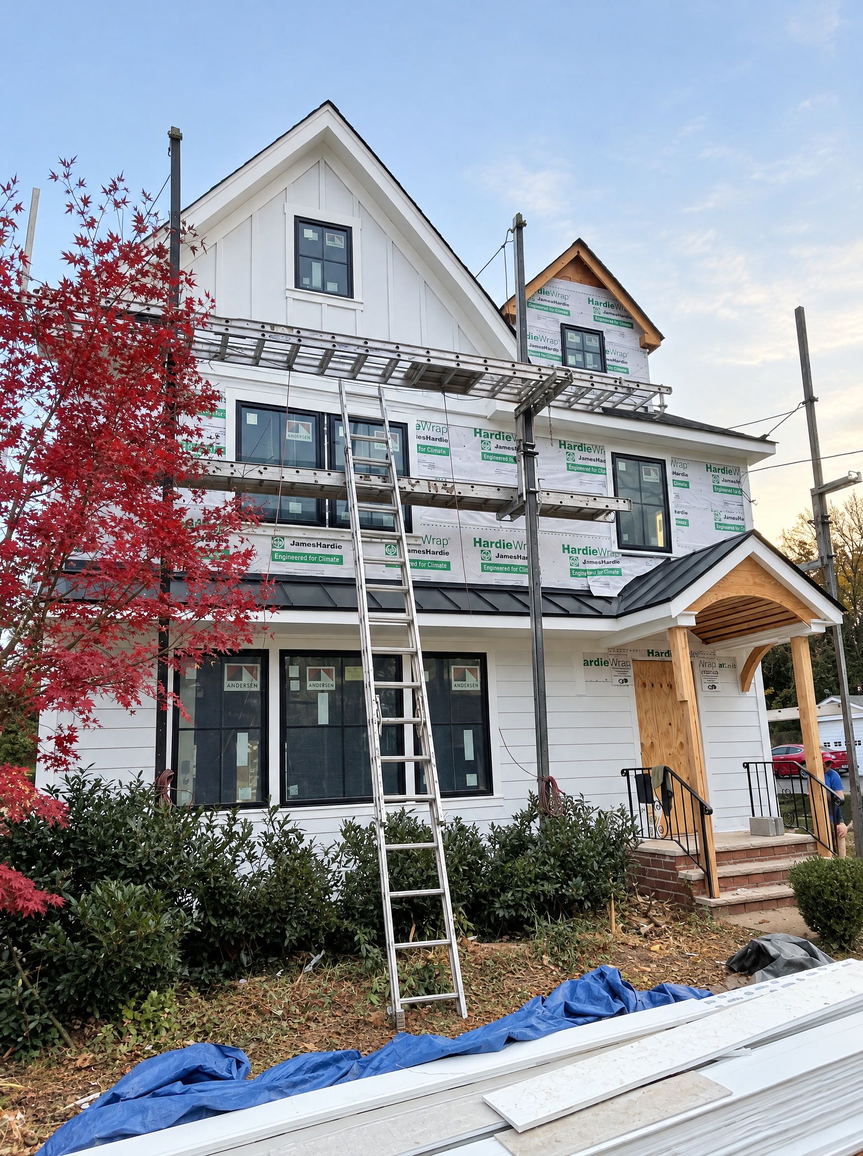The front with the porch roof on and the red maple, staging still up