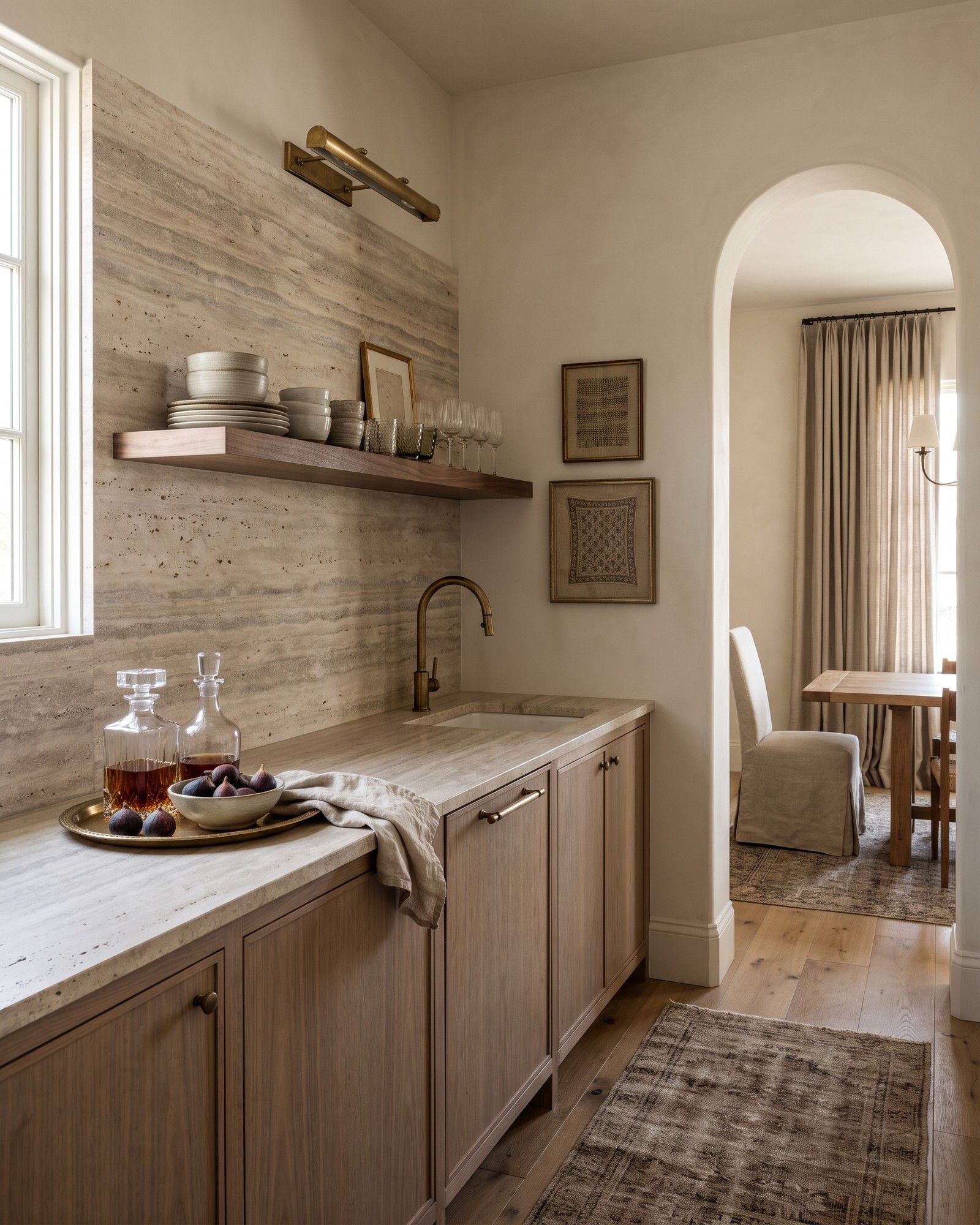 A butler's pantry with a backsplash and counter in honed vein-cut Silver Beige travertine, greige with fine bands, under bleached walnut cabinets