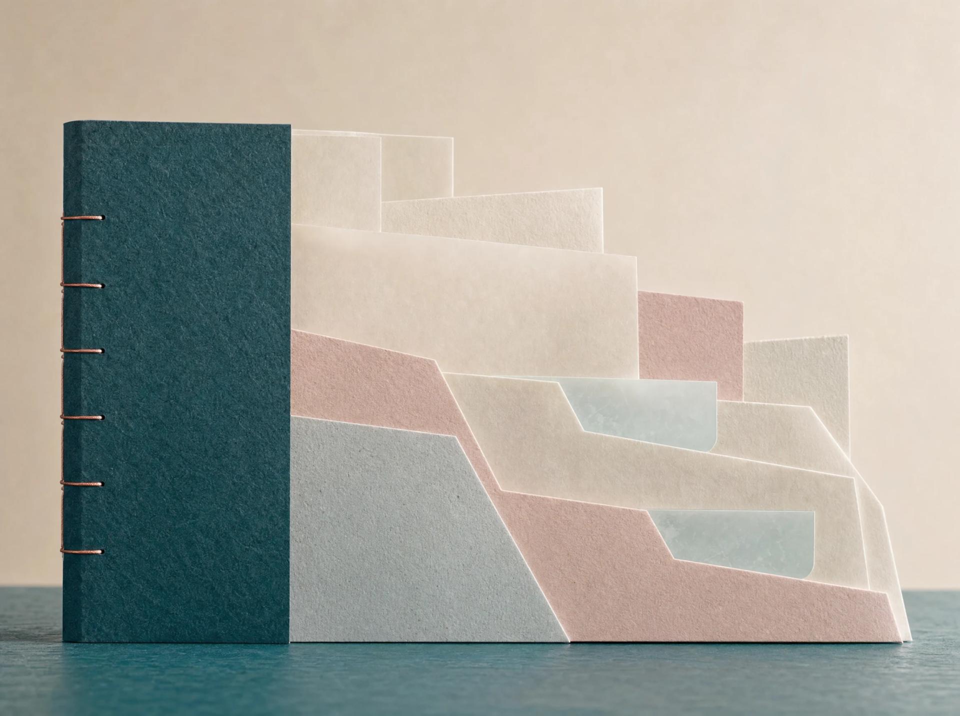Deep-teal bound archive holds staggered cream, blush and mist-blue folders and pages in one layered object.