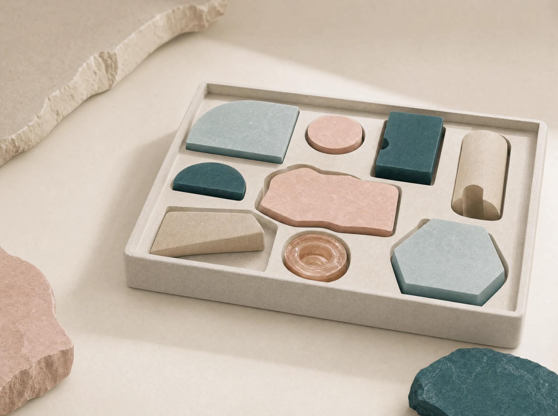 A fitted tray of distinct tactile tools in teal, blush, cream, copper, and mist blue.