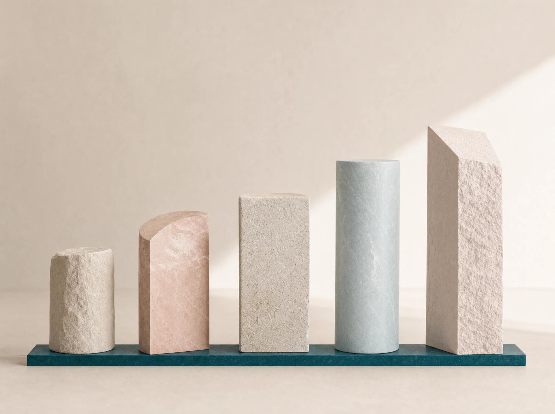 Five varied mineral columns aligned on one continuous teal operating base.