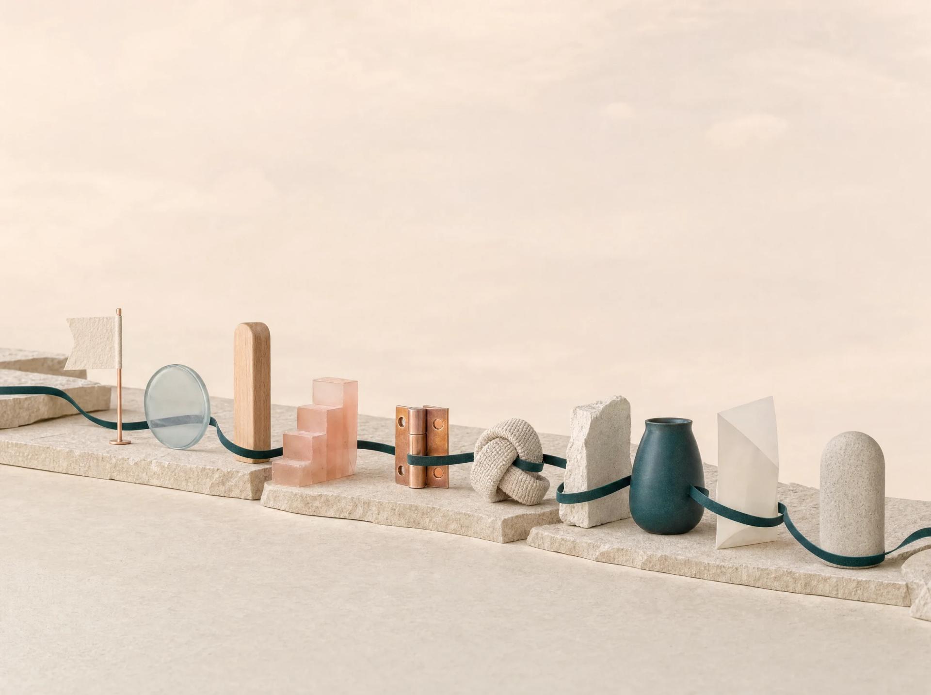 Continuous teal ribbon connects ten distinct material markers across a single pale mineral ledge.