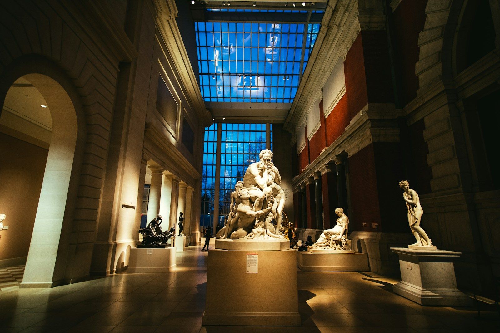 Museum gallery interior with sculptures and controlled lighting as a reference for gallery and showroom film locations