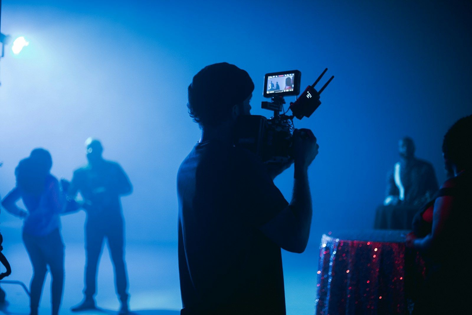 Camera operator in blue light as a symbol for music video location planning