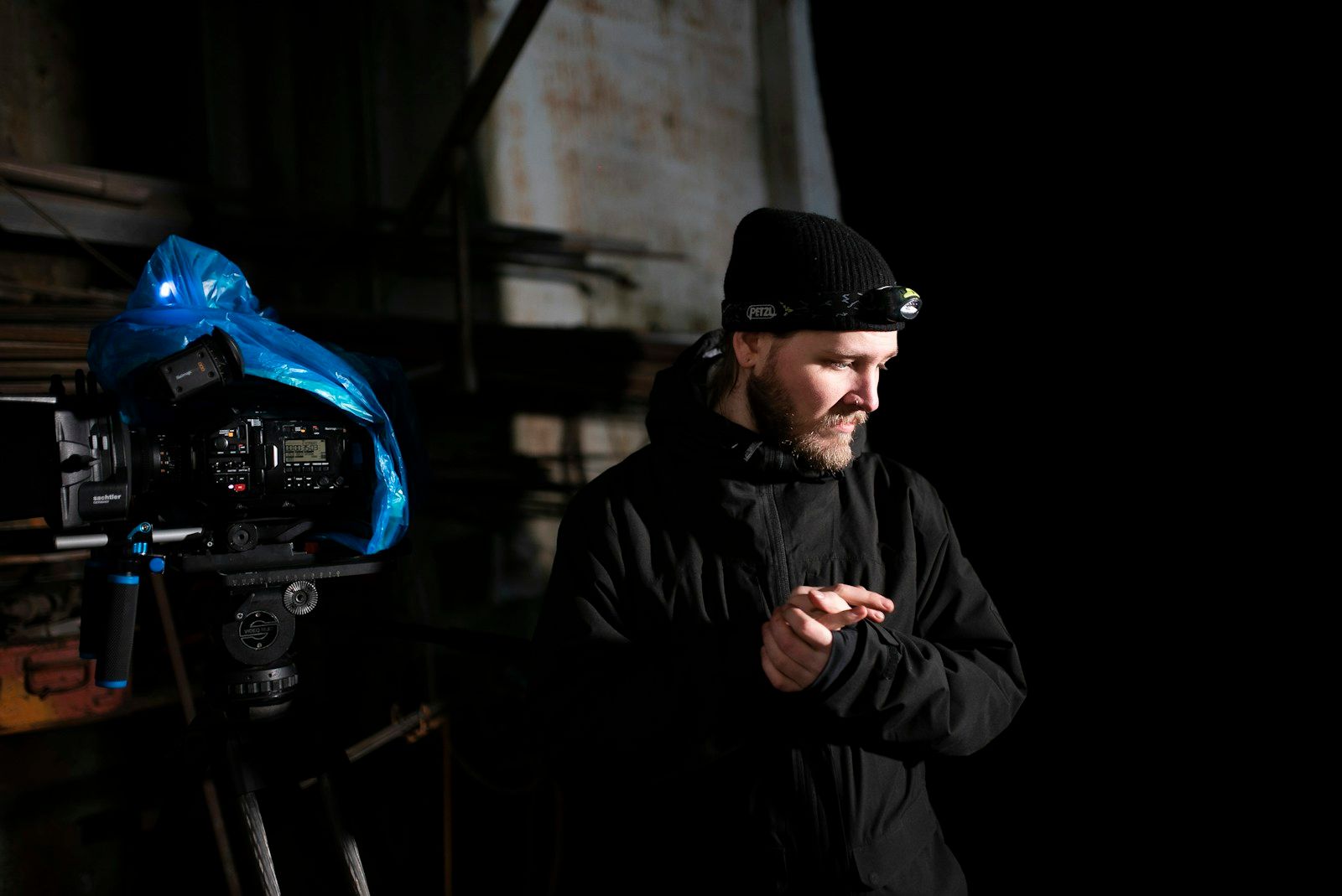 Camera operator working at night with a cinema camera and practical production lighting