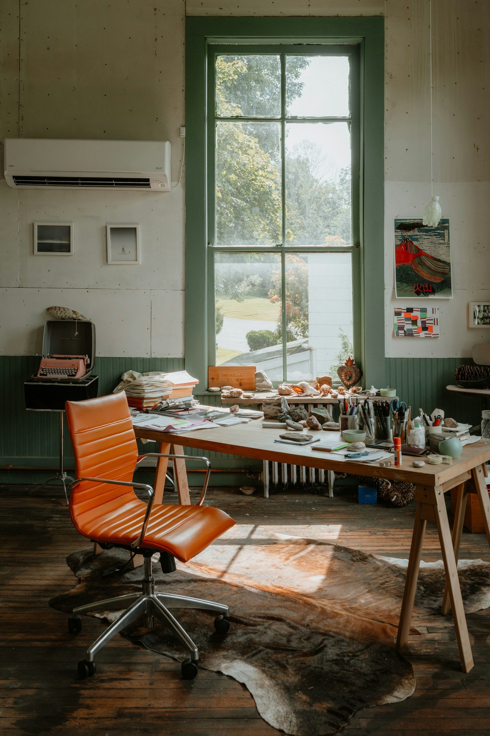 Artist studio with a desk, chair and large window as a reference for daylight studio and atelier photo locations