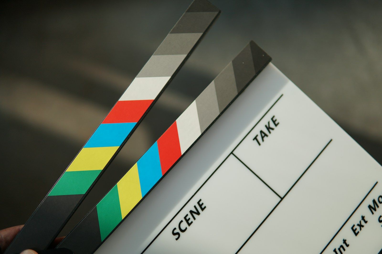 Hand holding a clapperboard as a production handoff reference for a location brief