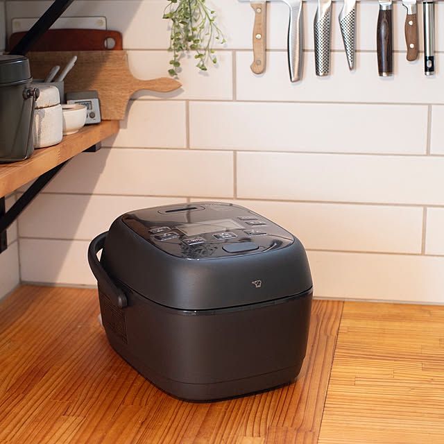 A compact 3-cup rice cooker on a Japanese kitchen counter