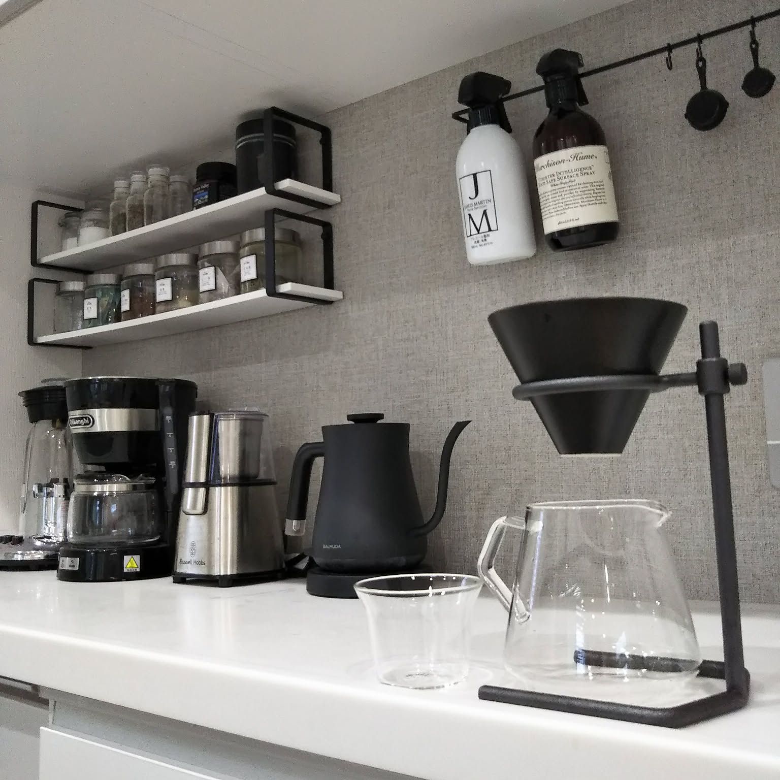 Small coffee station with dripper stand, kettle, grinder, and narrow shelves