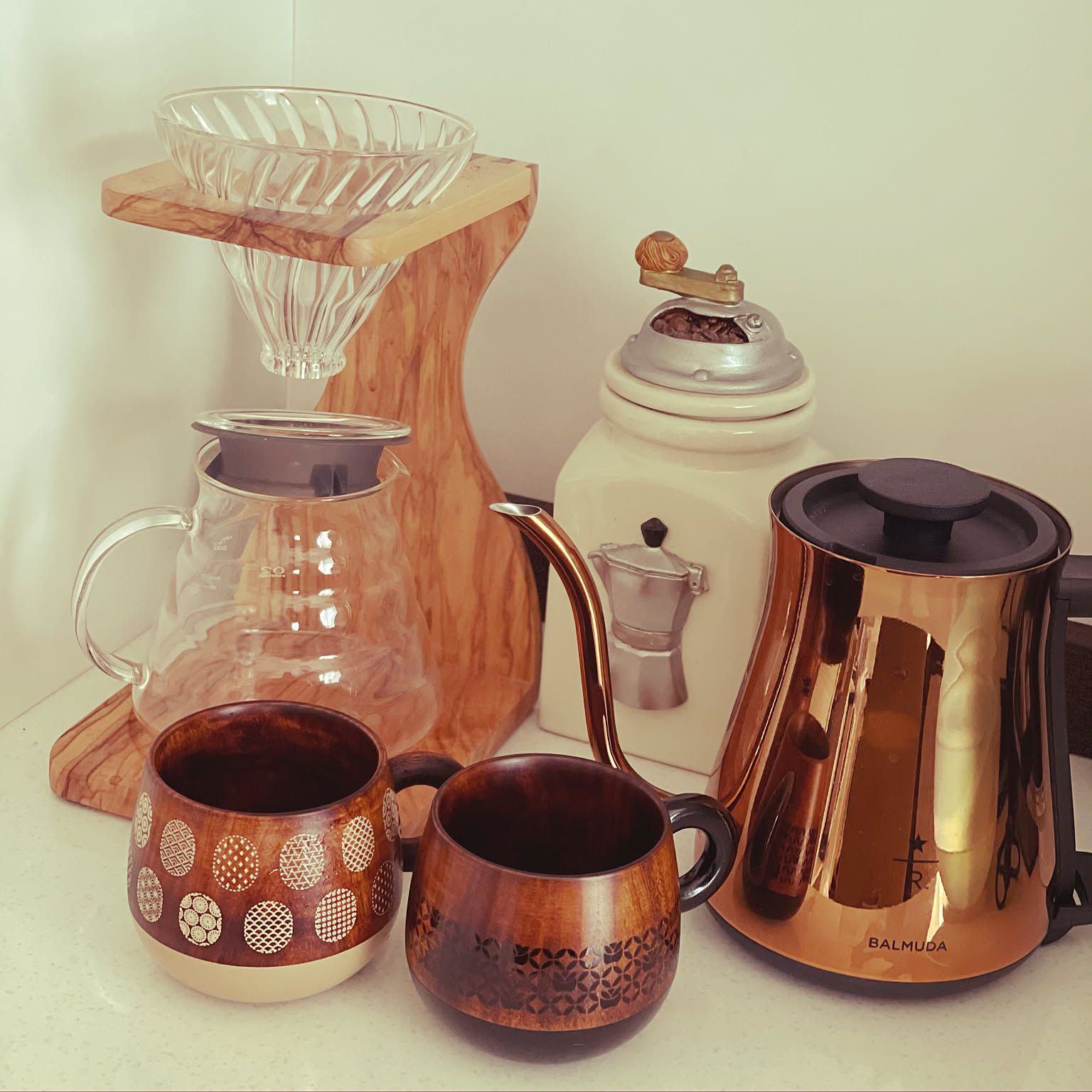 HARIO V60 olive wood stand set with a server, dripper, kettle, cups, and grinder.