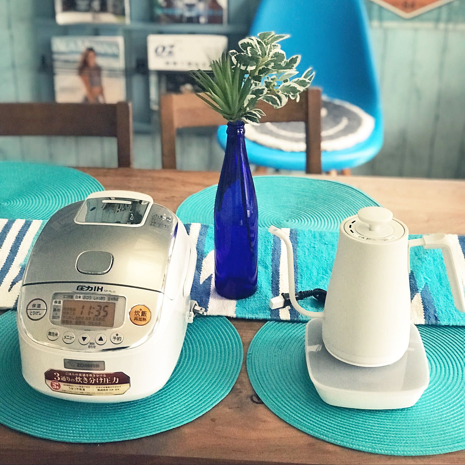 A white Zojirushi 3-cup pressure IH rice cooker shown clearly on a blue dining table.