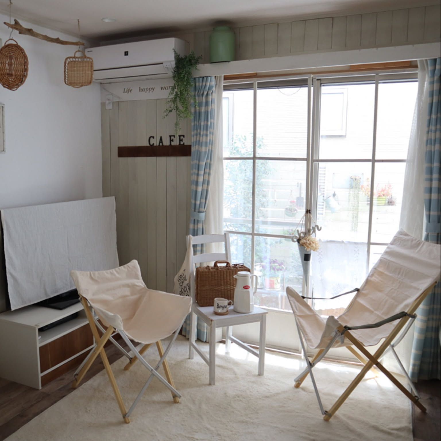 Two cream canvas Snow Peak Take! Chairs in a bright Japanese living room