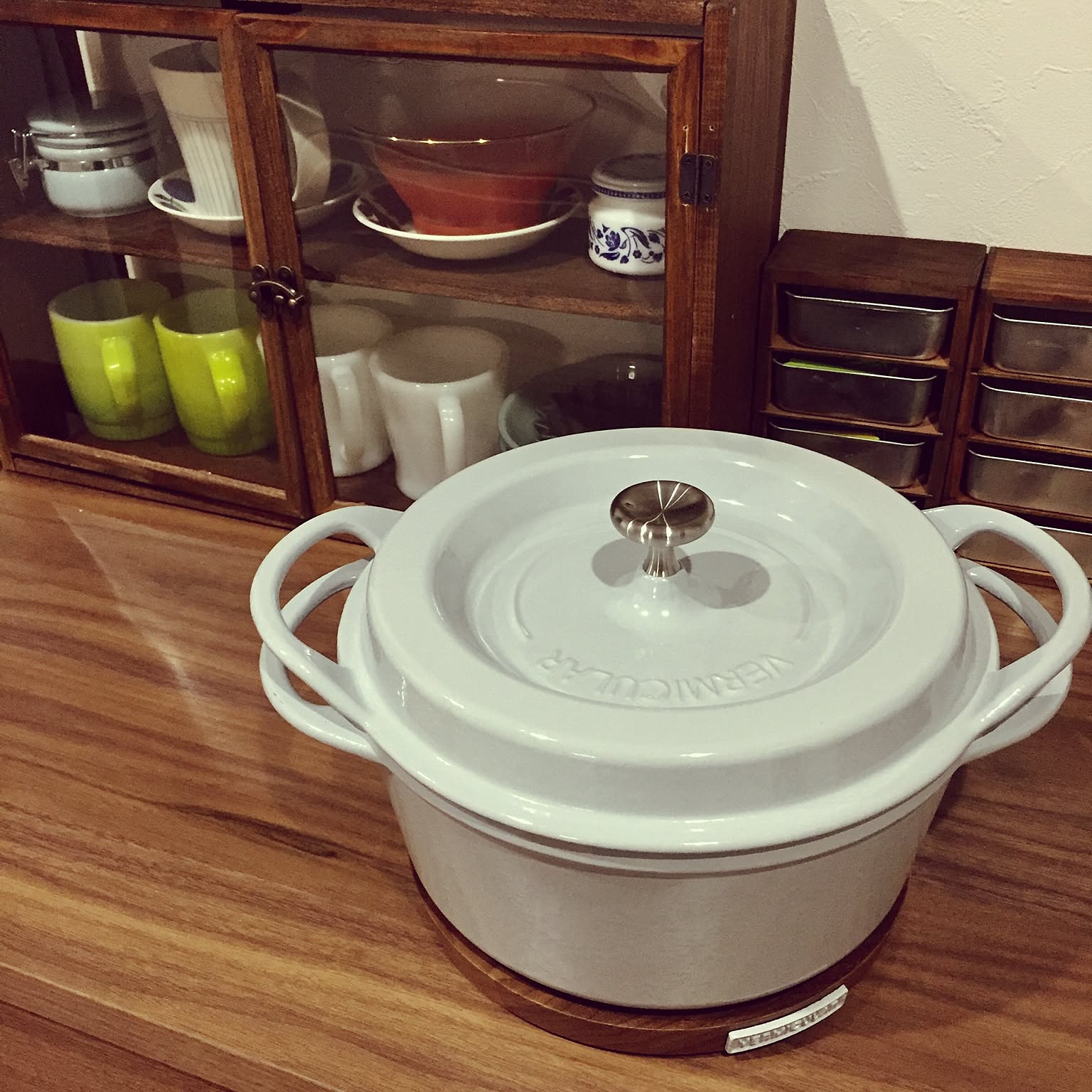 An original Vermicular Oven Pot on a wooden magnetic trivet in a Japanese kitchen