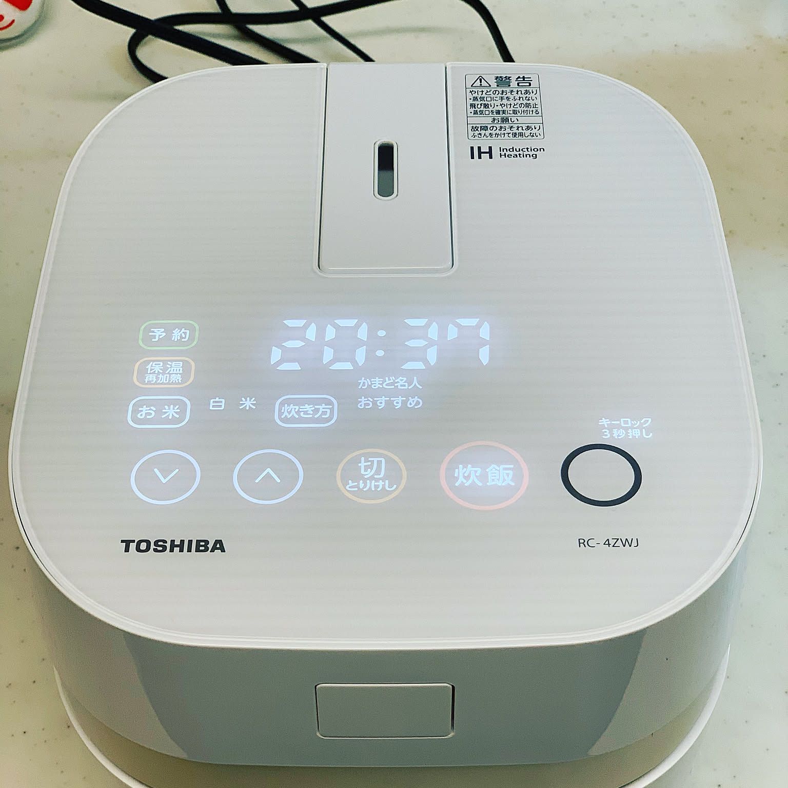 A Toshiba IH rice cooker shown in close-up with its control panel visible.