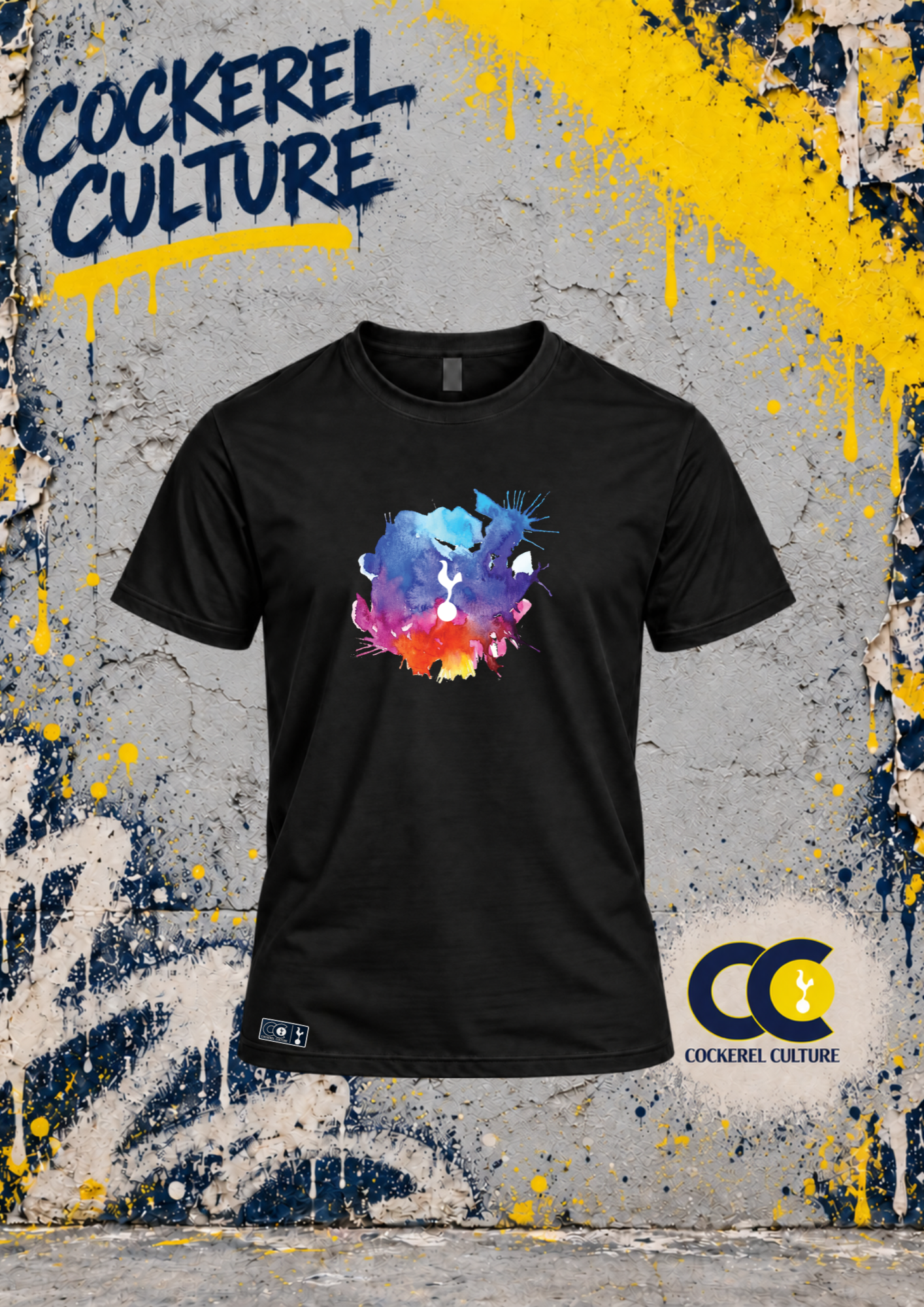A black t-shirt with the cockerel picked out of a splash of watercolour in blue, purple, pink and orange across the chest, seen from the front.