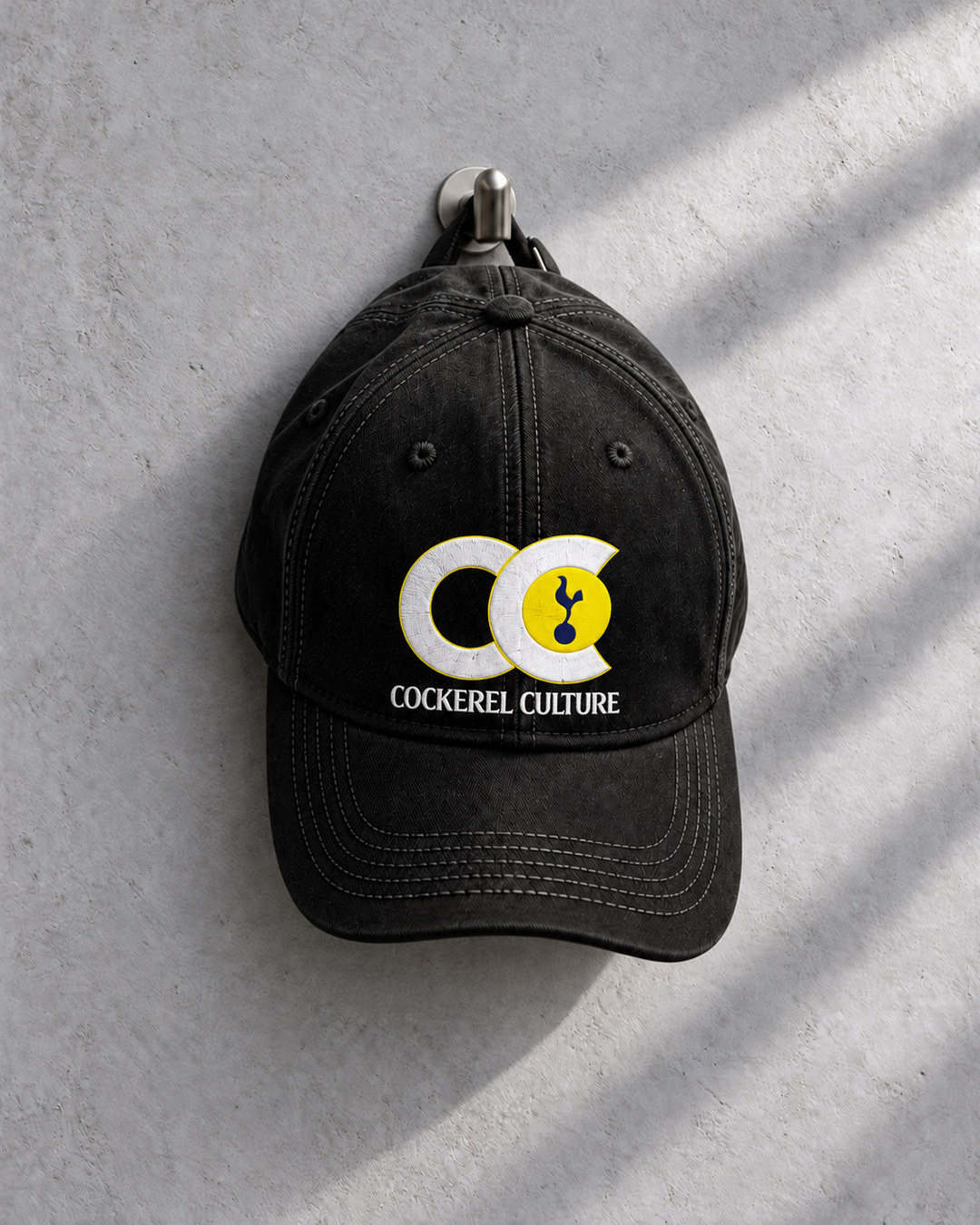 Cockerel Culture cap in black, three-quarter front view with the CC logo