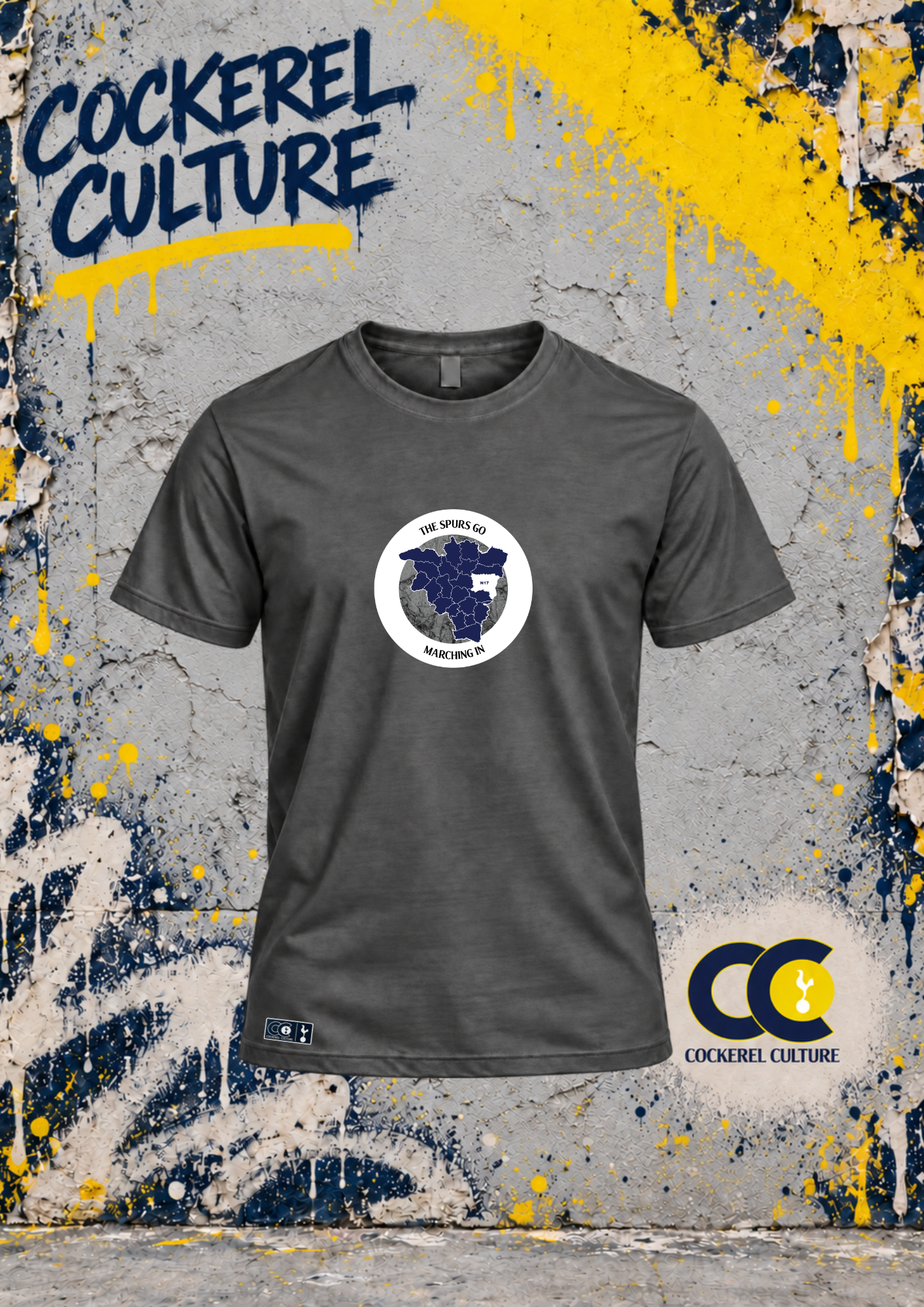 A dark grey t-shirt with a circular badge holding a map of the North London boroughs, with the words The Spurs Go Marching In set around the ring across the chest, seen from the front.