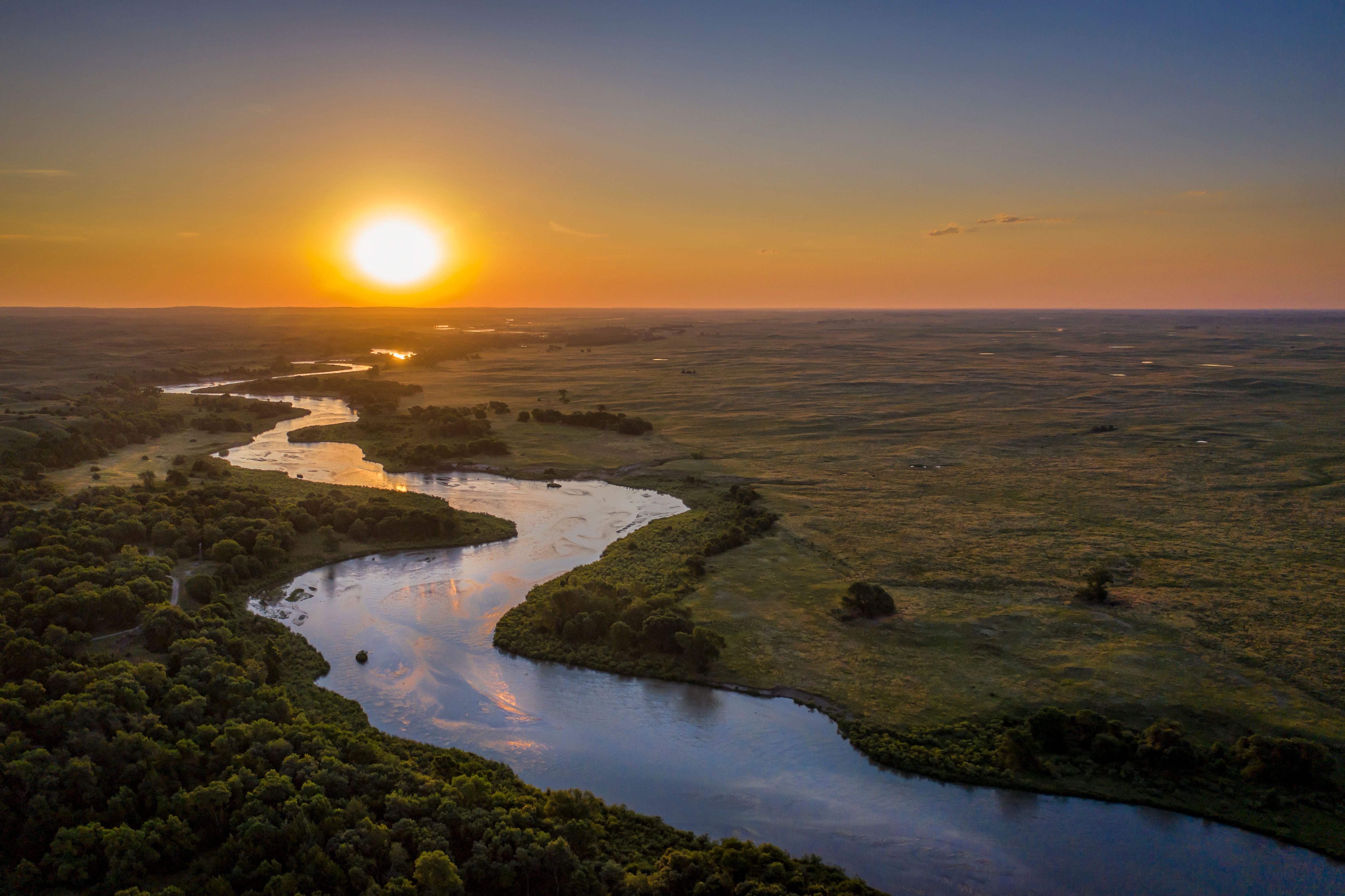 Sun sets over winding river in Nebraska