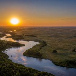Sun sets over winding river in Nebraska