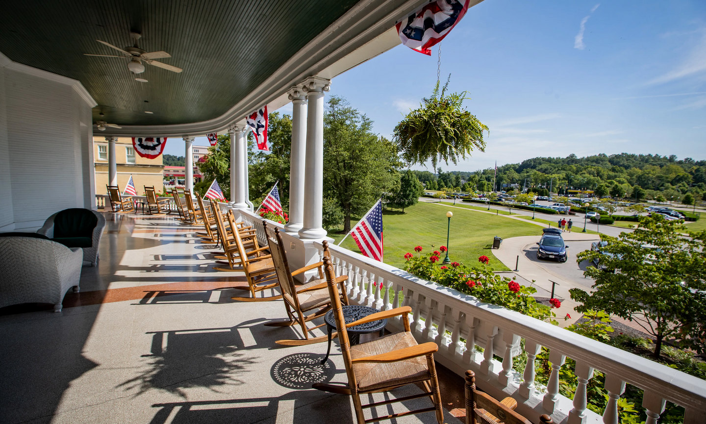 A porch overlooks the green landscaping of French Lick Resort