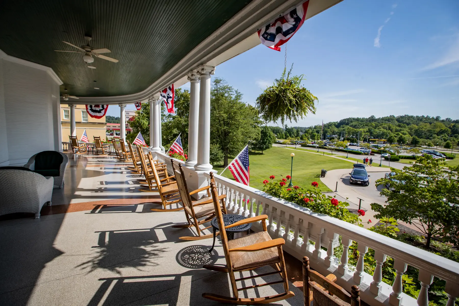 A porch overlooks the green landscaping of French Lick Resort