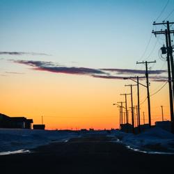 The sun sets over houses in Curtis, Nebraska