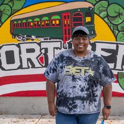 Elwood Resident in front of Fort Ben Mural (Credit: City of Elwood)