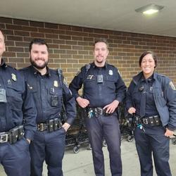 Four Jackson Police Department officers in uniform smiling for a photo together.