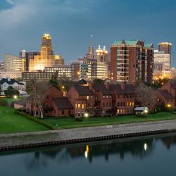 Brick buildings and skyscrapers appear across a river in Buffalo, New York