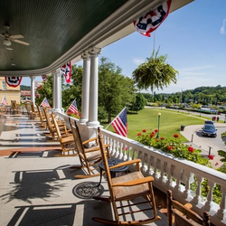 A porch overlooks the green landscaping of French Lick Resort
